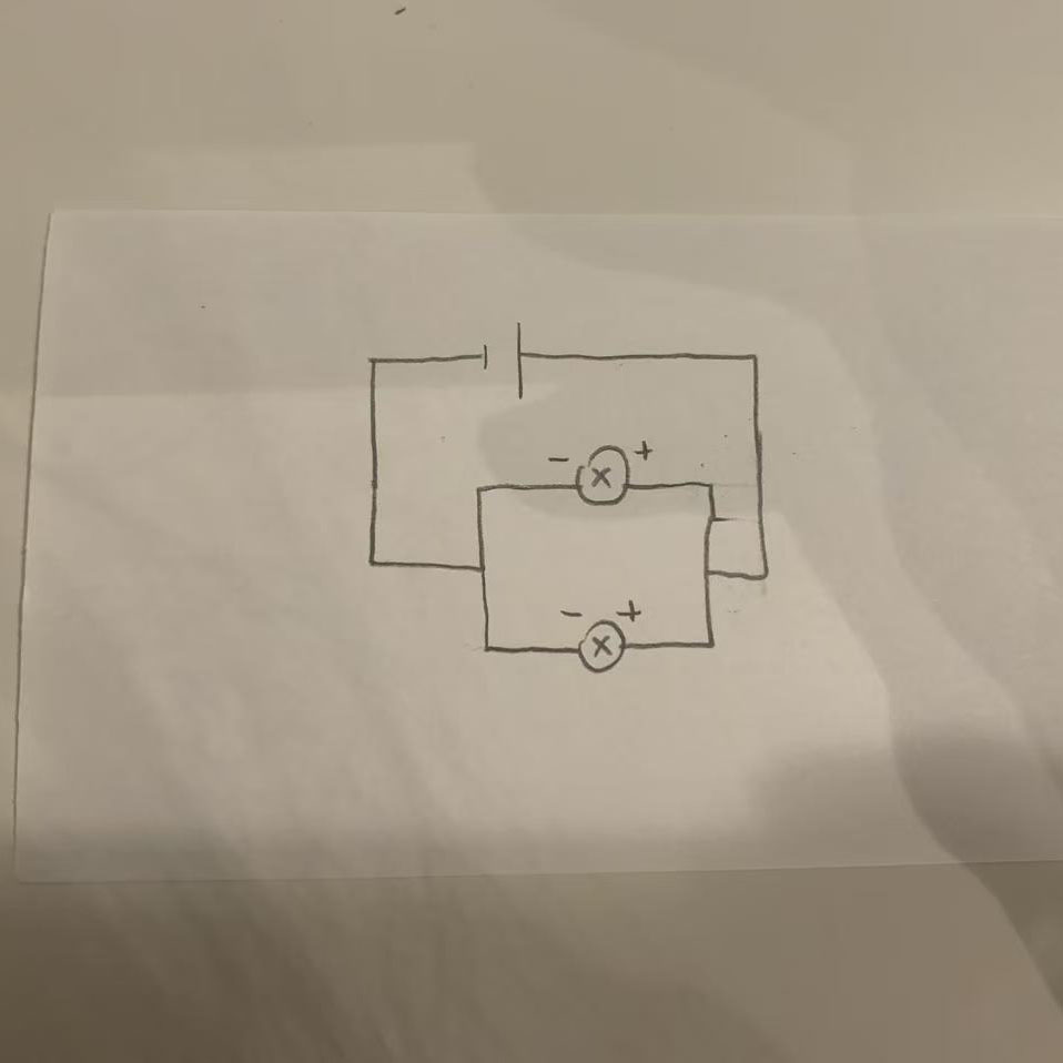 I sketched a circuit diagram with two linked loops, featuring two LEDs powered by a single battery.