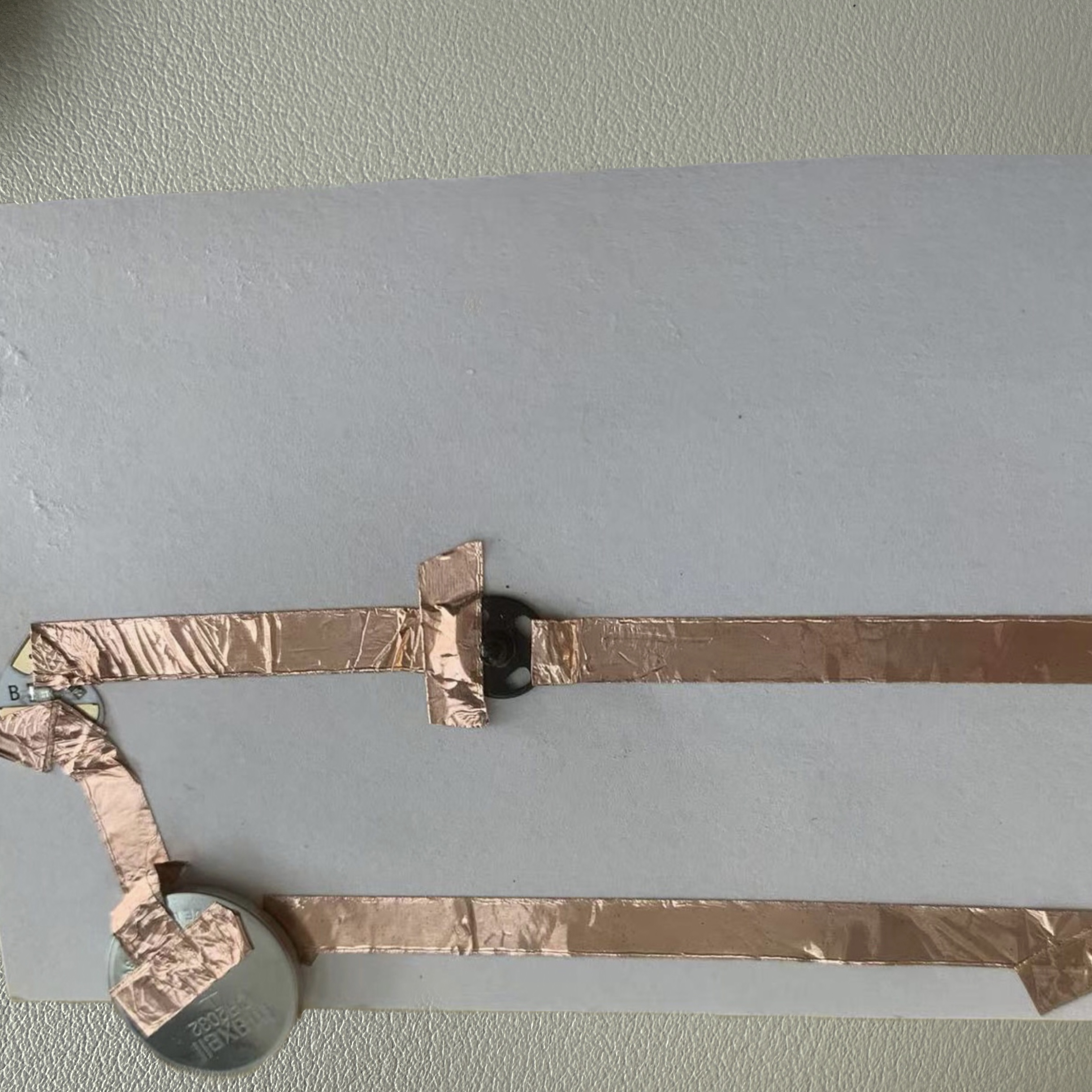 I assembled the circuit using copper tape, a coin battery, and an LED, ensuring all components were connected as shown in my diagram.