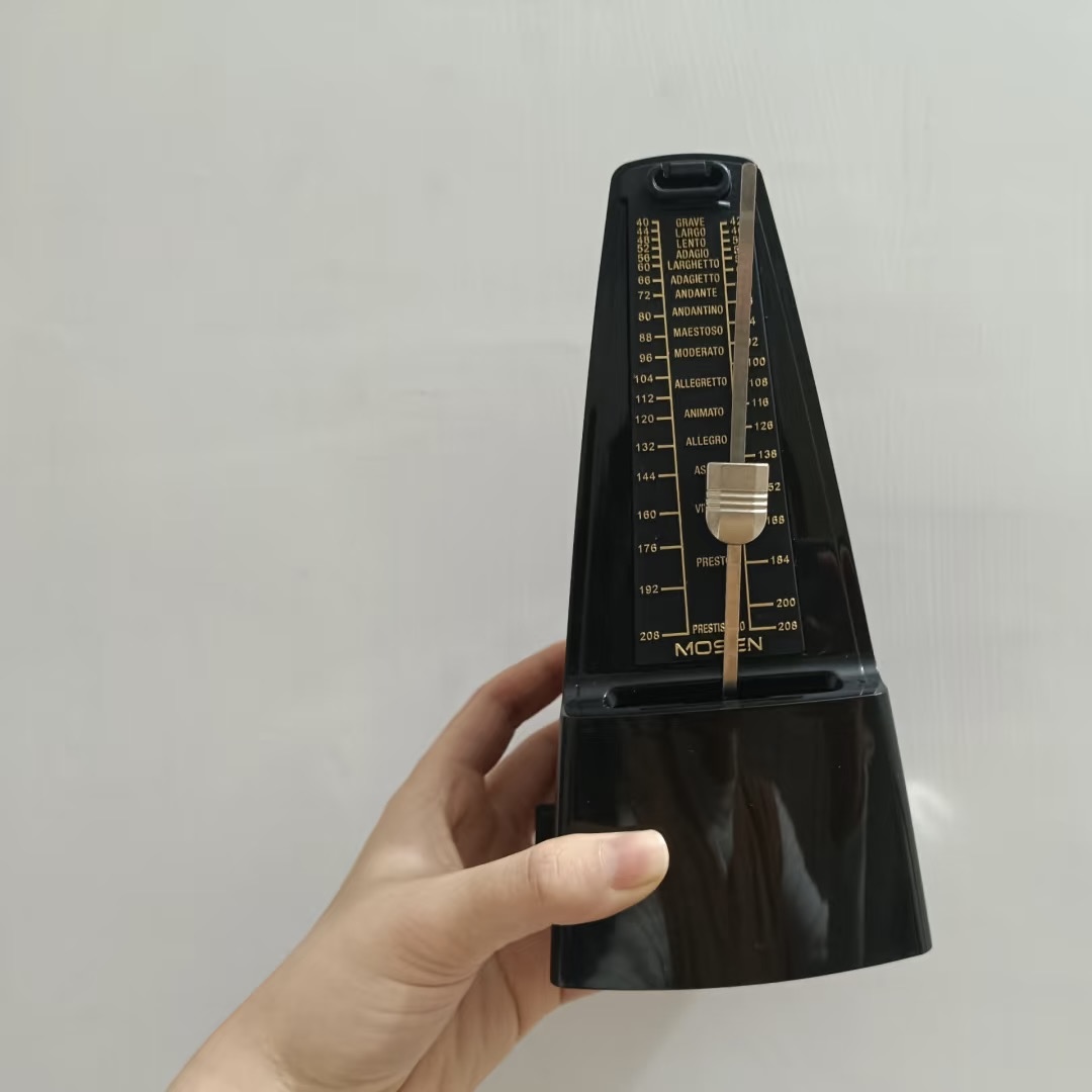 The steady tick-tock beat of a metronome swinging back and forth.