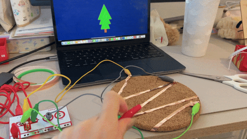 An interactive moment with a soft pastel animation. The visual changes with Makey Makey touch, simulating the soothing motion of a flower blooming.